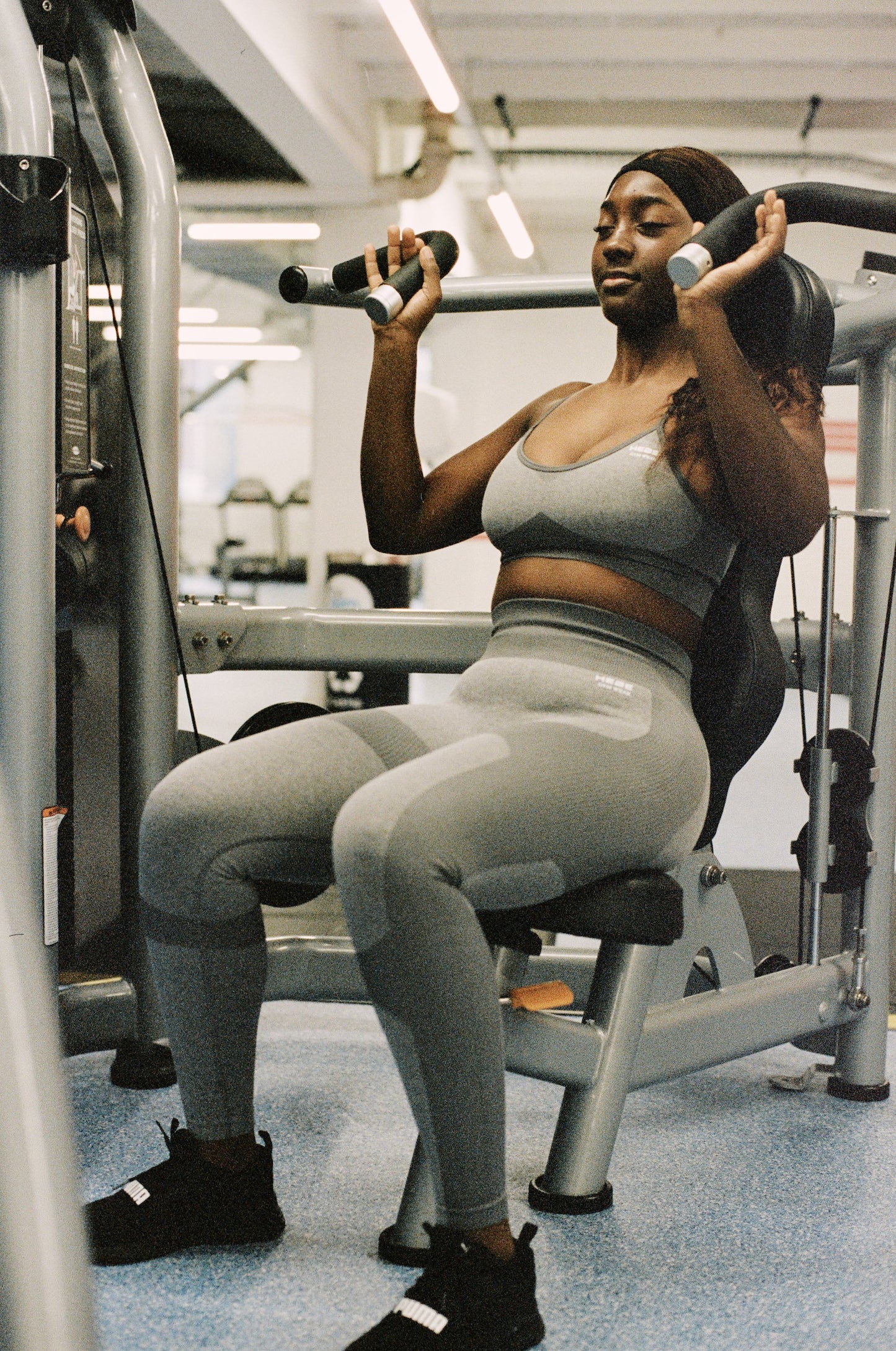 woman wearing grey gym wear working out