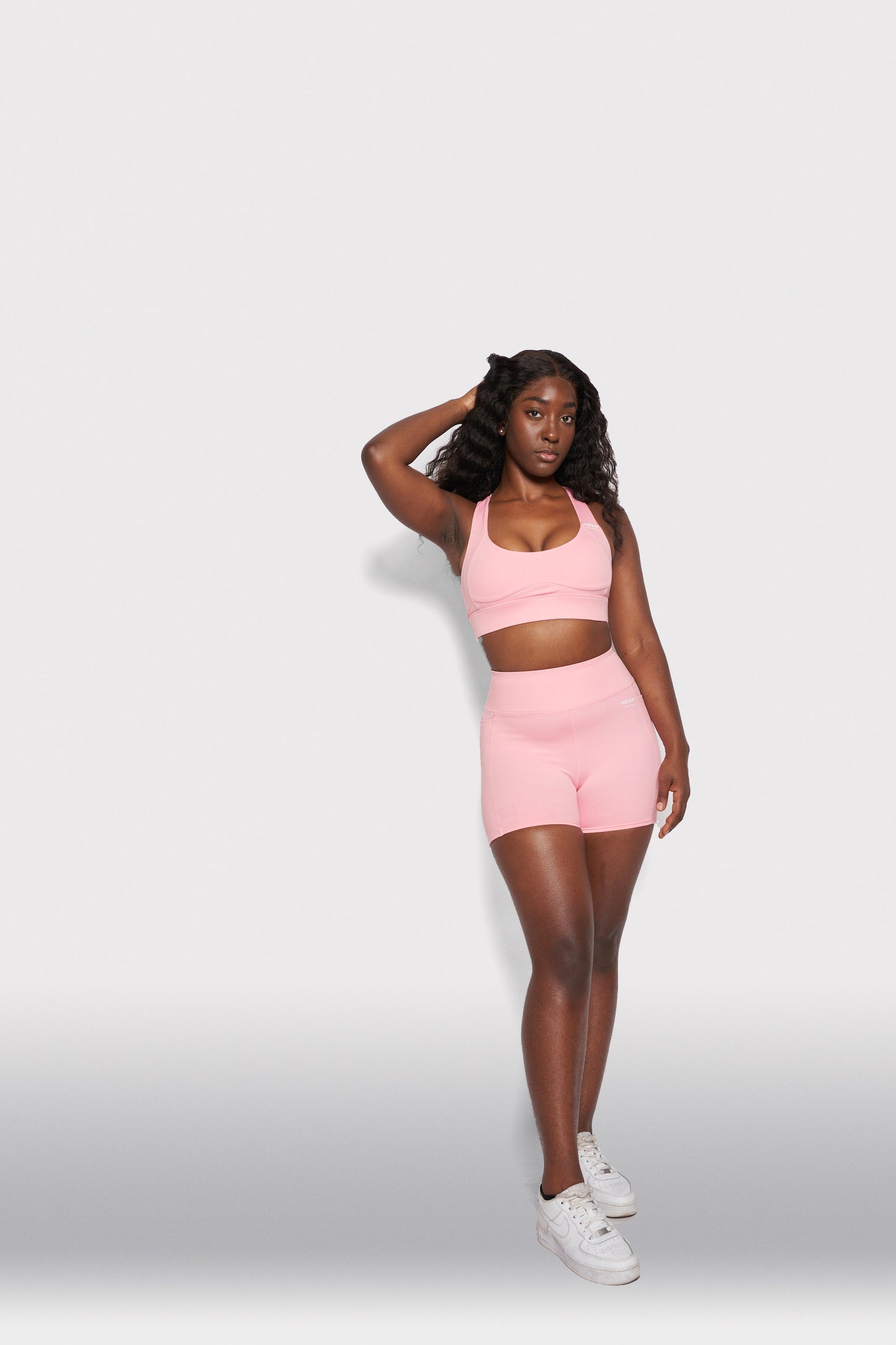 girl in pink hebe shorts and bra top gymwear set